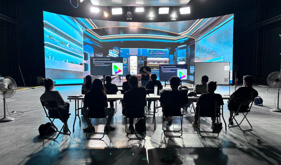ICVFX training session on the LED volume — students seated on stage with instructor presenting, LED wall active behind